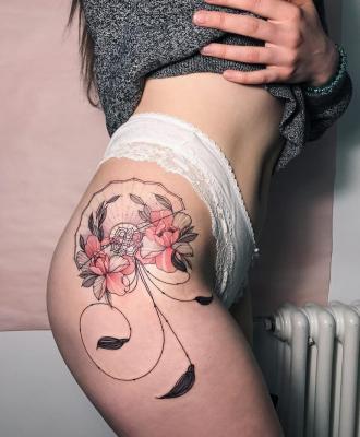 Kobiecy tatuaż na udzie 